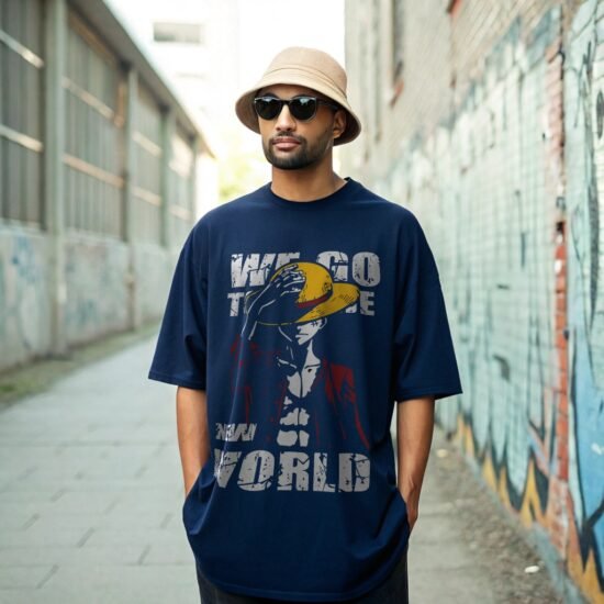 A man wearing dark navy blue oversized t-shirt in summer days outdoor back alley graffiti wall and standing straight facing camera hand in the pocket, wearing sun glass and summer hat.